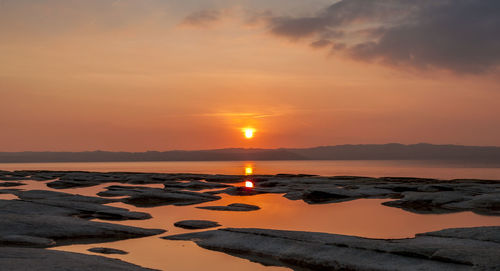 Scenic view of sea against romantic sky at sunset