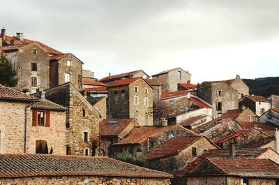 Houses in town against sky