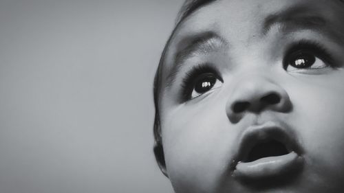 Close-up portrait of cute boy against white background