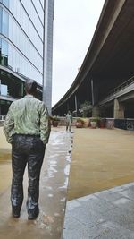 Full length of man standing against built structure