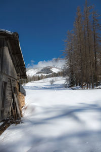 Wooden shack in winter day with fresh snow in the mountains.