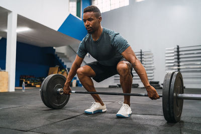 Full length of man exercising in gym