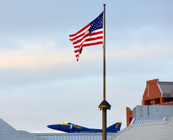 Low angle view of flag against blue sky