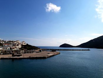 Scenic view of sea by city against sky