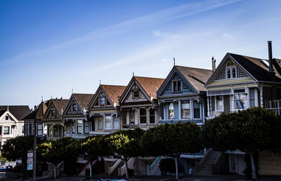 Low angle view of buildings against blue sky