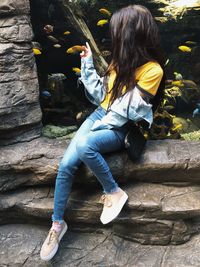 Woman sitting on rock