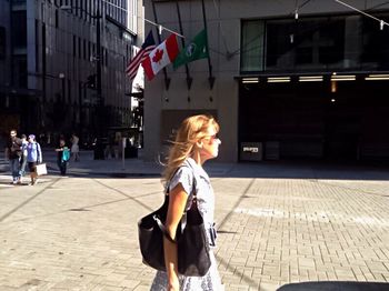 Woman standing on street in city