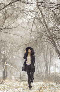 Full length of a man standing in forest