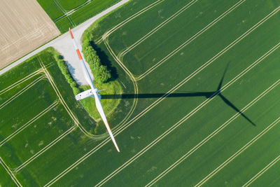 Wind turbine seen vertical from above with shadow