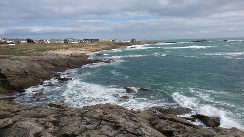 Scenic view of sea against cloudy sky