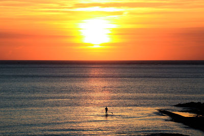 Scenic view of calm sea at sunset