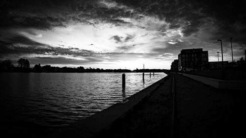 Scenic view of river against sky at sunset