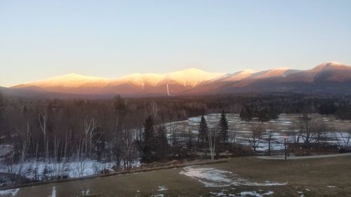 Scenic view of mountains against clear sky during winter