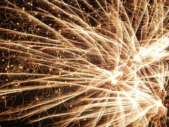 Low angle view of firework display at night