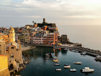 High angle view of buildings by sea against sky