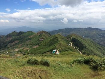 Scenic view of landscape against cloudy sky