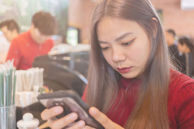 Portrait of beautiful young woman using mobile phone