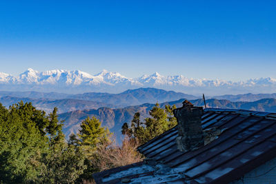 Scenic view of snowcapped mountains against clear blue sky