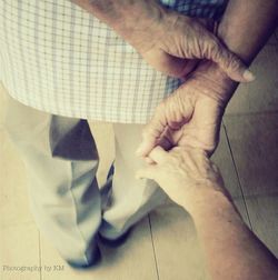 Cropped image of man holding hands