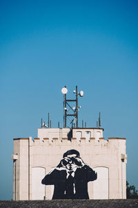 Silhouette of woman against clear blue sky