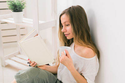 Young woman sitting at home