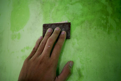 Close-up of hand on wall