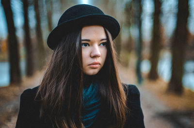 Portrait of beautiful young woman wearing hat