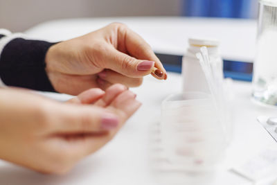 Cropped hands of doctor examining patient