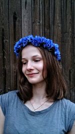 Smiling young woman wearing blue flowers