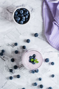 A glass of blueberry smoothie on the table. antioxidant organic healthy food. top and vertical view