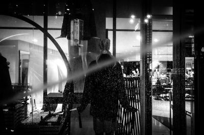 Man standing in illuminated city at night