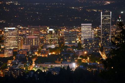 High angle view of illuminated buildings in city at night