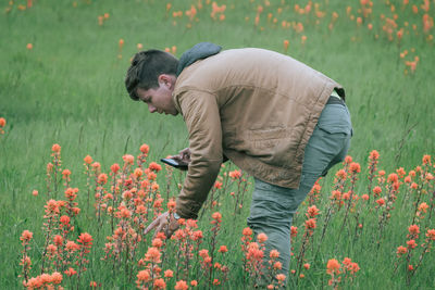 Side view of man standing on field