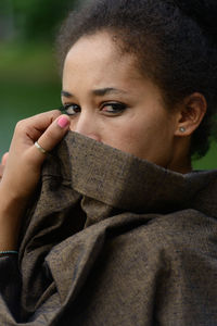 Close-up portrait of young woman with eyes closed