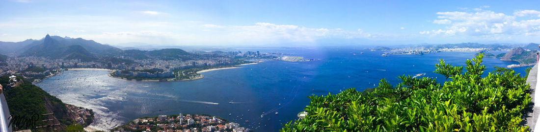 High angle view of sea and cityscape against sky