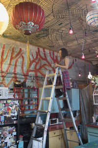 Low angle view of lighting equipment hanging on ceiling