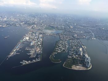 High angle view of city by buildings against sky