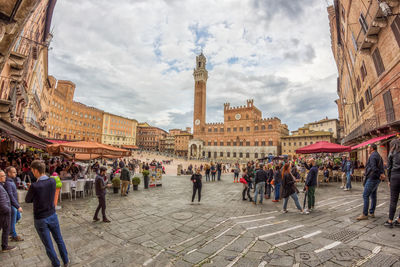 People at town square against sky