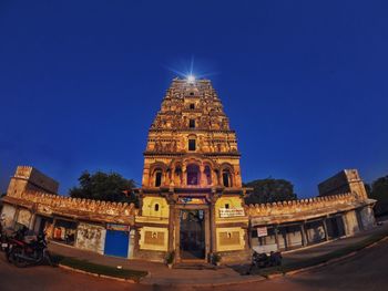 Illuminated building against blue sky at dusk