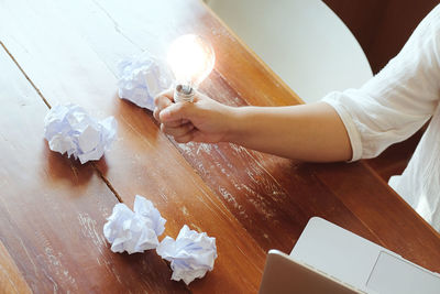 High angle view of woman holding umbrella on paper