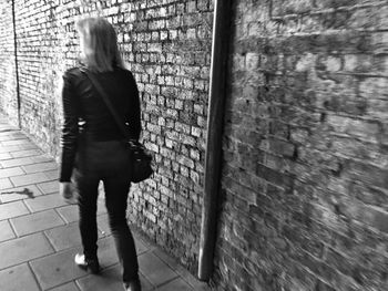 Full length of young man standing on wall