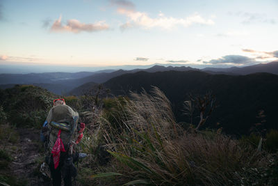 Man standing on mountain against sky