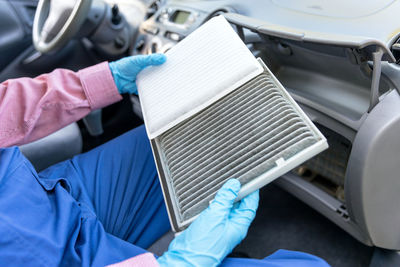 Close-up of hands working in car