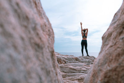 Full length of woman standing on rock