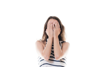 Close-up of young woman against white background