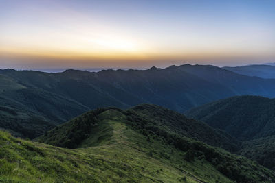 Scenic view of mountains against sky during sunset