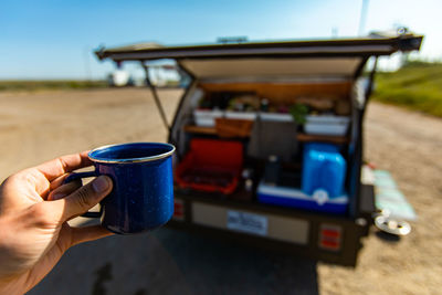 Midsection of man holding coffee cup