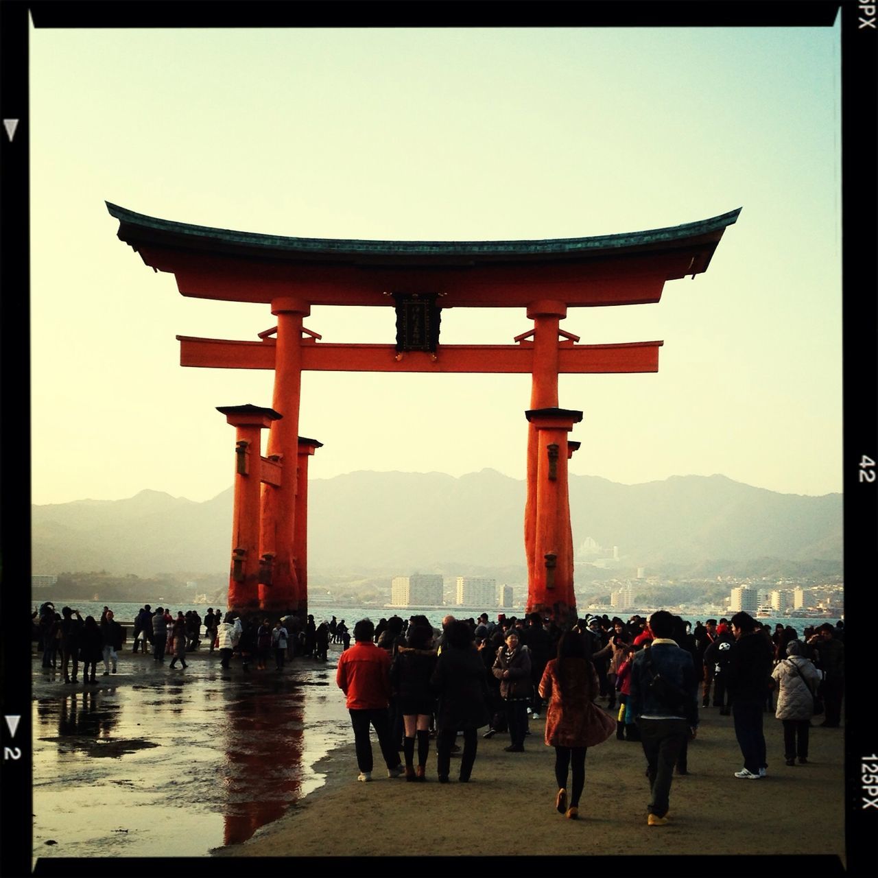 large group of people, person, transfer print, men, built structure, architecture, lifestyles, tourist, leisure activity, mixed age range, tourism, mountain, auto post production filter, famous place, travel destinations, travel, clear sky, sky, building exterior