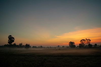 Scenic view of field against sky during sunset