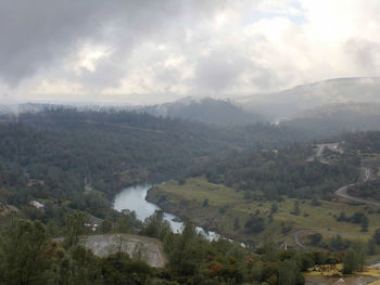 Scenic view of mountains against cloudy sky